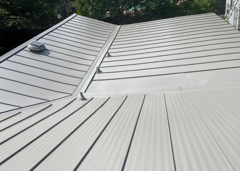 Solar attic fan installed on a metal roof for Roof Ventilation in Valley City